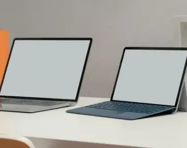 Cropped shot two blank screen laptop office desk with books decorations home office room 67155 9530