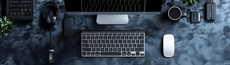 Modern desktop workspace with monitor, wireless keyboard, mouse, headphones, and tech accessories representing a professional laptop store in UAE offering business laptops, computers, and IT solutions.